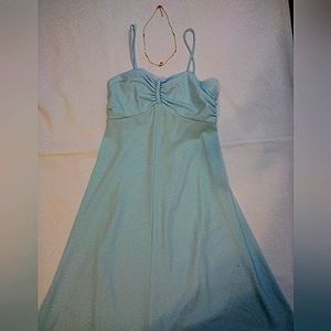 A blue satin midi dress with beaded necklace